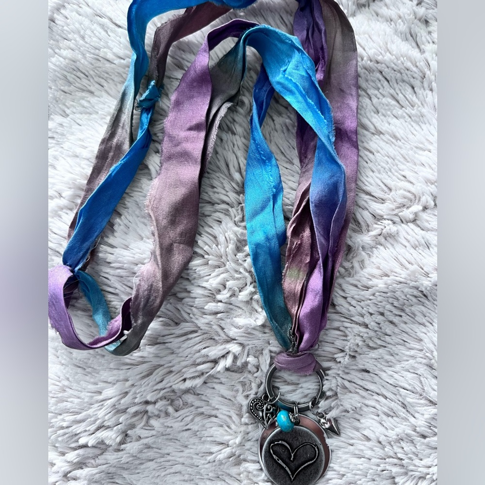 Handmade necklace with fabric chain and heart pendant.